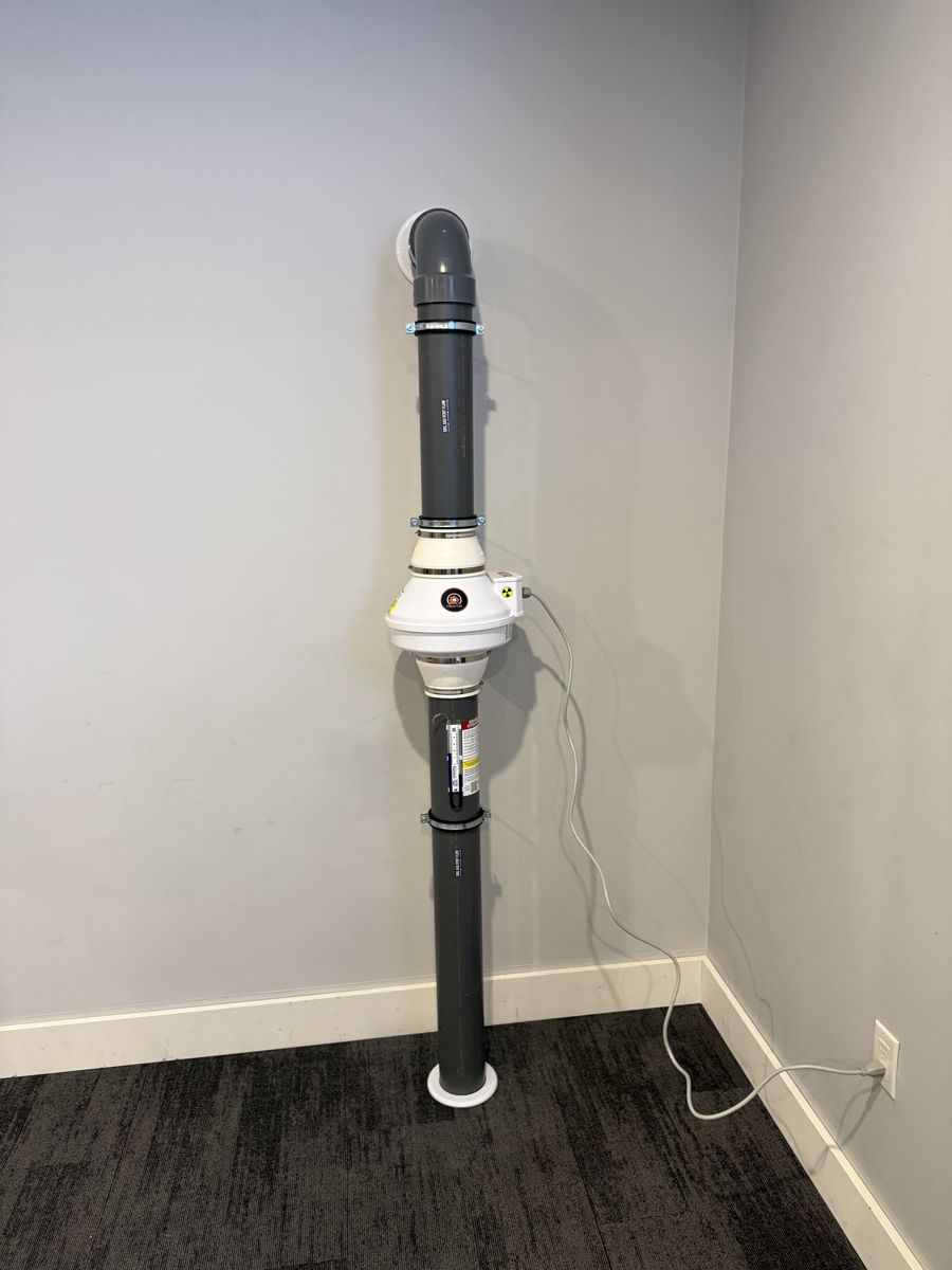 Radon mitigation system with a Fantech fan carrying the Cleya Ltd. logo