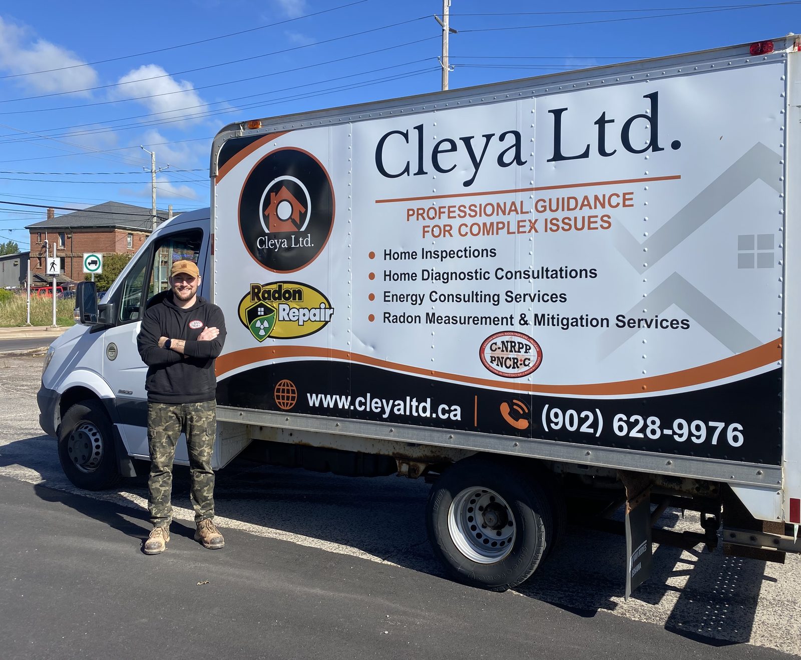 Zackary Hennessey standing beside the Cleya Ltd. service truck